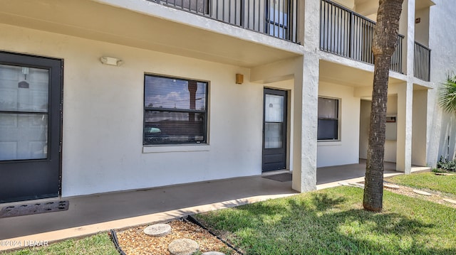 view of exterior entry with a yard