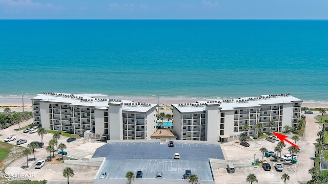 drone / aerial view with a water view and a view of the beach