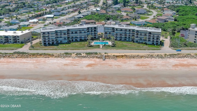 drone / aerial view with a water view and a beach view