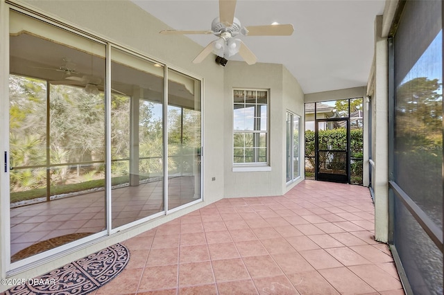 unfurnished sunroom featuring ceiling fan