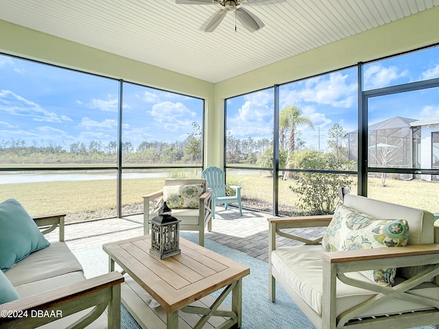 sunroom / solarium featuring a water view and ceiling fan