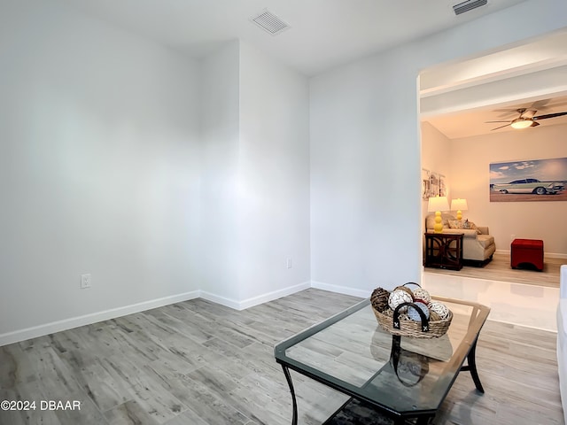 sitting room with wood-type flooring and ceiling fan