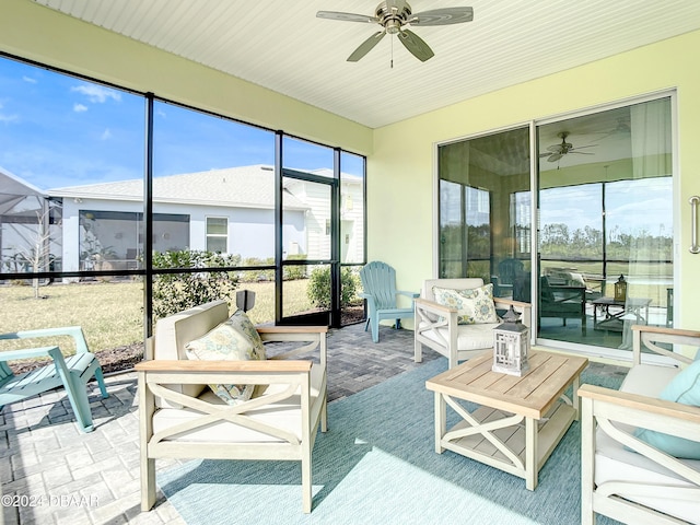 sunroom / solarium featuring ceiling fan