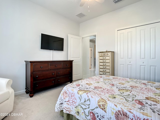 carpeted bedroom with a closet and ceiling fan