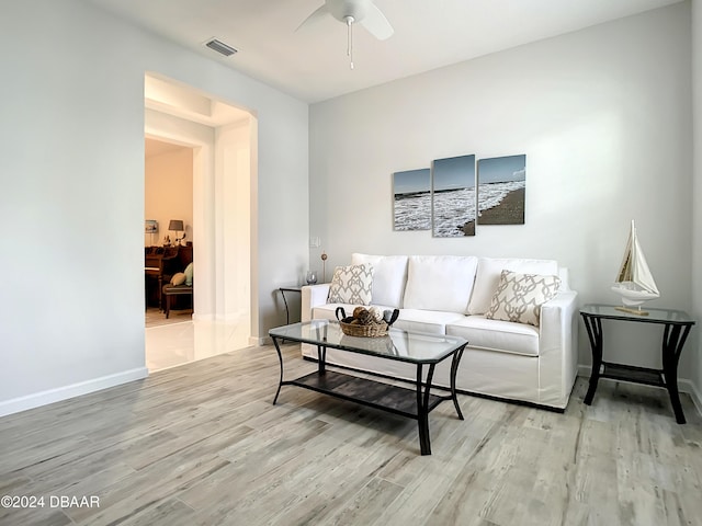 living room with light hardwood / wood-style flooring and ceiling fan