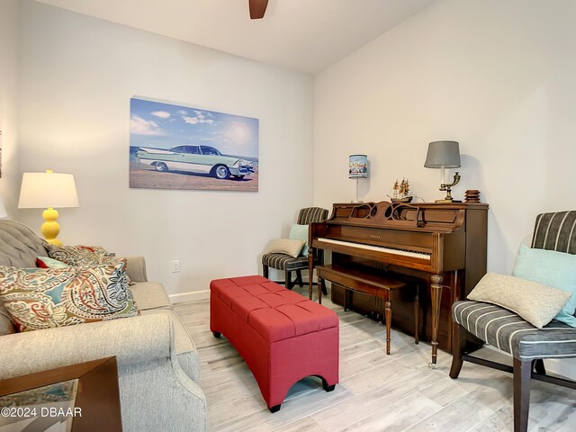 sitting room featuring hardwood / wood-style flooring, vaulted ceiling, and ceiling fan