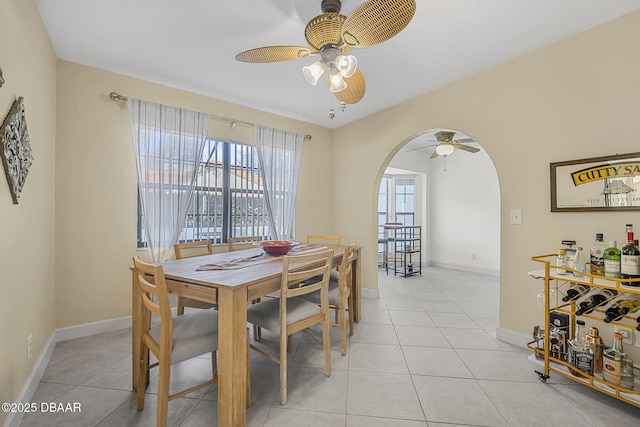 tiled dining space featuring ceiling fan