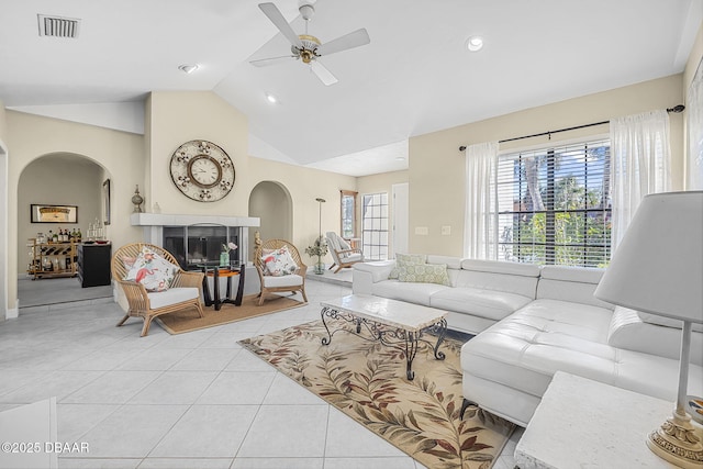 tiled living room with vaulted ceiling and ceiling fan