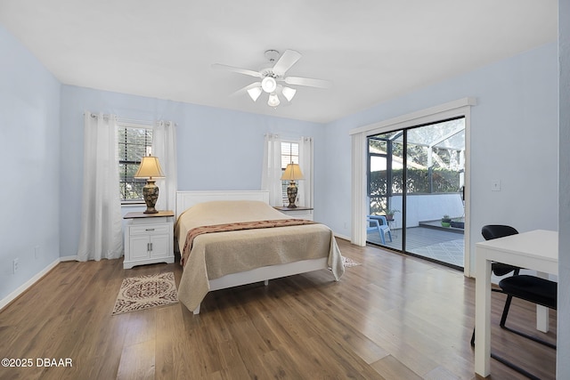 bedroom featuring multiple windows, access to exterior, wood-type flooring, and ceiling fan