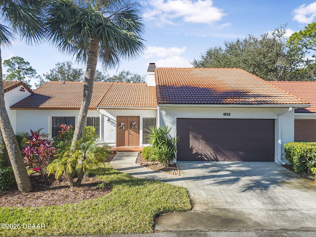 mediterranean / spanish-style house featuring a garage