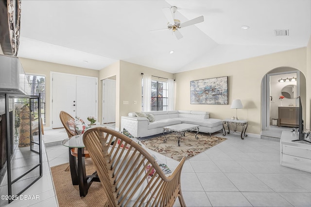 tiled living room with vaulted ceiling and ceiling fan