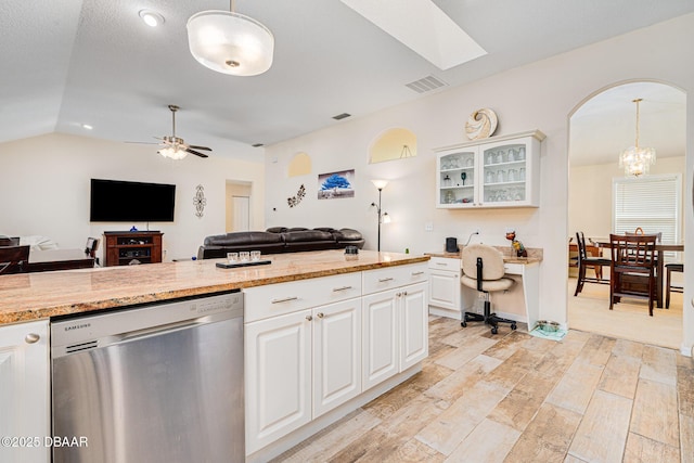kitchen with open floor plan, visible vents, ceiling fan with notable chandelier, glass insert cabinets, and dishwasher