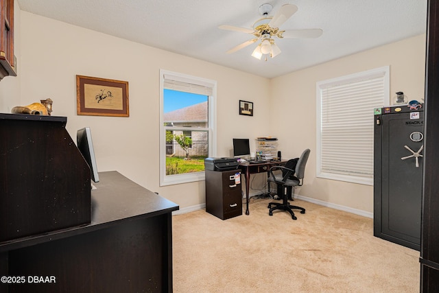 office area with ceiling fan, baseboards, and light colored carpet