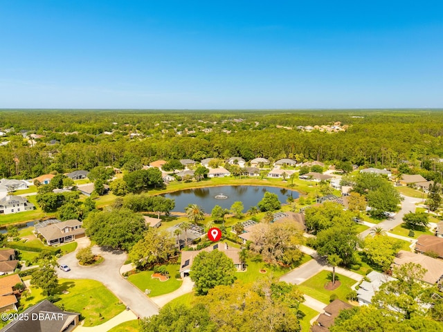 birds eye view of property featuring a wooded view, a residential view, and a water view
