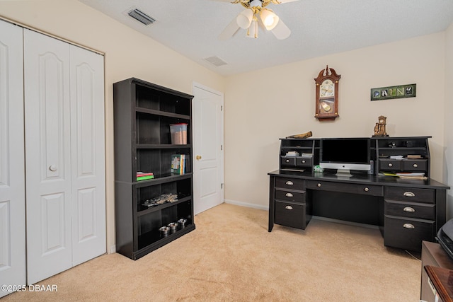 home office with ceiling fan, baseboards, visible vents, and light colored carpet