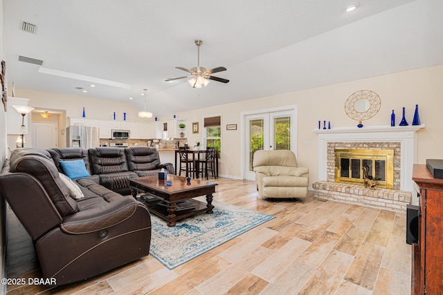 living area featuring ceiling fan, lofted ceiling, visible vents, and recessed lighting