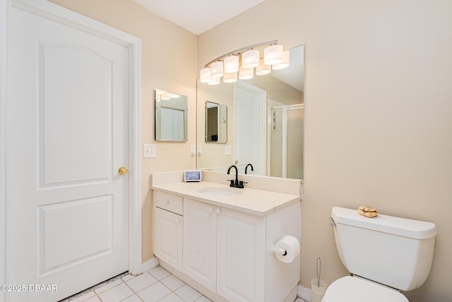 full bathroom with a shower stall, tile patterned flooring, toilet, vanity, and baseboards