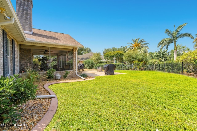 view of yard featuring a fenced backyard, a ceiling fan, and a patio