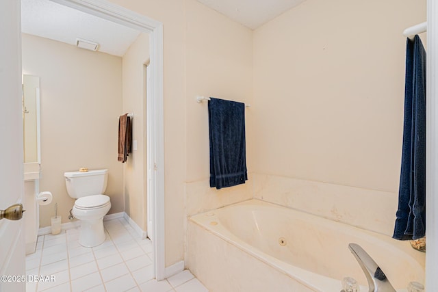 bathroom with baseboards, a whirlpool tub, tile patterned flooring, and toilet
