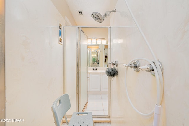 full bath featuring visible vents, vanity, and a shower