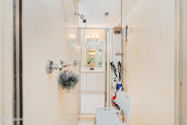 bathroom with vanity, a textured ceiling, and visible vents