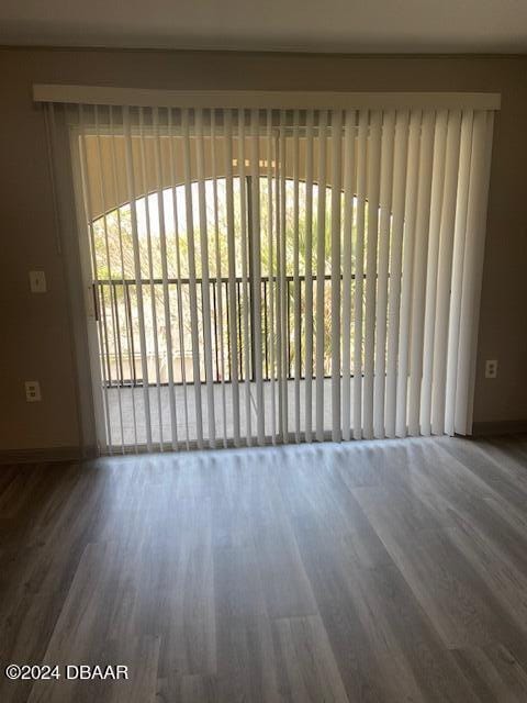 940 Village Trl Unit 6-305, Port Orange, FL 32127 - unfurnished room featuring baseboards and wood finished floors