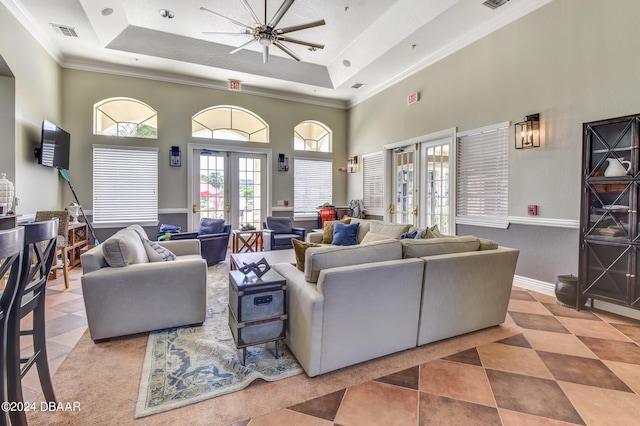 940 Village Trl Unit 6-305, Port Orange, FL 32127 - living room with tile patterned floors, a tray ceiling, a towering ceiling, crown molding, and ceiling fan