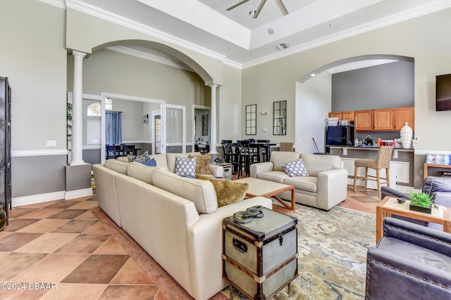 940 Village Trl Unit 6-305, Port Orange, FL 32127 - living area with ornate columns, arched walkways, a towering ceiling, light tile patterned floors, and a tray ceiling