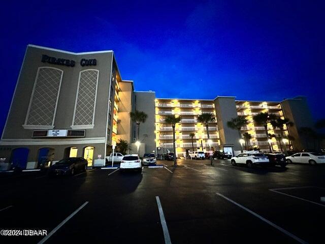 3501 S Atlantic Ave E Unit G20, Daytona Beach Shores, FL 32118 - property at night featuring uncovered parking
