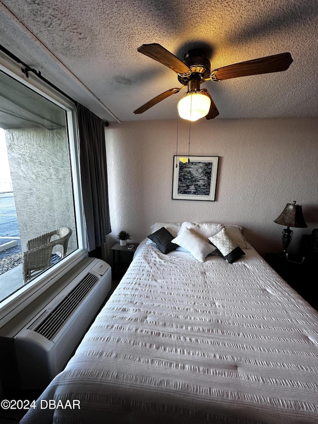 3501 S Atlantic Ave E Unit G20, Daytona Beach Shores, FL 32118 - bedroom with a textured wall, a textured ceiling, and ceiling fan