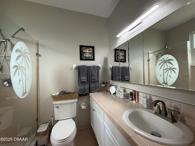 415 Jessamine Ave, New Smyrna Beach, FL 32169 - bathroom with a tile shower, toilet, vanity, and tile patterned floors