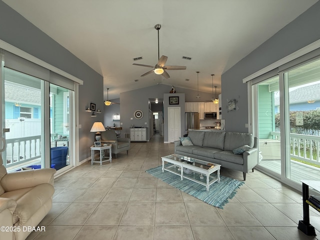415 Jessamine Ave, New Smyrna Beach, FL 32169 - living area with a ceiling fan, vaulted ceiling, and light tile patterned floors