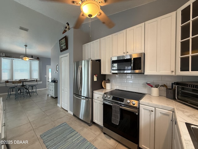 415 Jessamine Ave, New Smyrna Beach, FL 32169 - kitchen featuring stainless steel appliances, ceiling fan, decorative backsplash, light countertops, and white cabinets