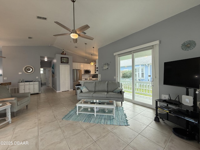 415 Jessamine Ave, New Smyrna Beach, FL 32169 - living area with light tile patterned floors, a ceiling fan, and high vaulted ceiling