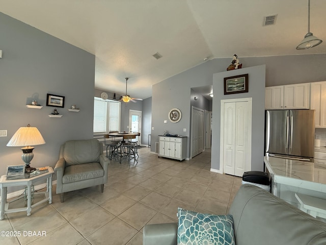 415 Jessamine Ave, New Smyrna Beach, FL 32169 - living room featuring lofted ceiling, ceiling fan, light tile patterned flooring, and baseboards