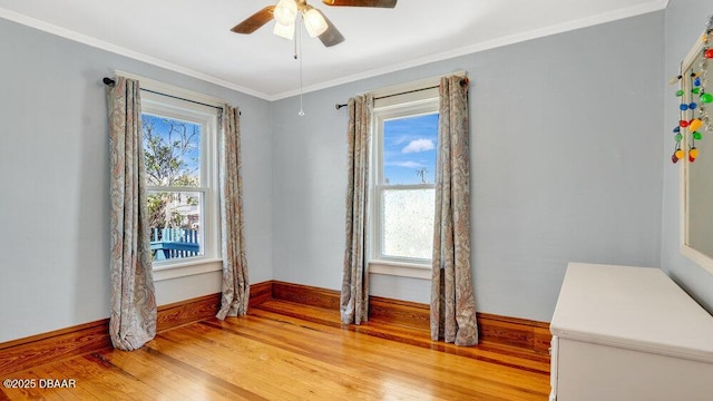 spare room with ornamental molding, hardwood / wood-style floors, and ceiling fan