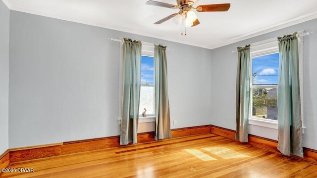 empty room with hardwood / wood-style flooring, ornamental molding, and ceiling fan