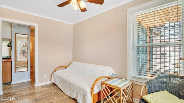 living area with hardwood / wood-style floors, crown molding, and a healthy amount of sunlight