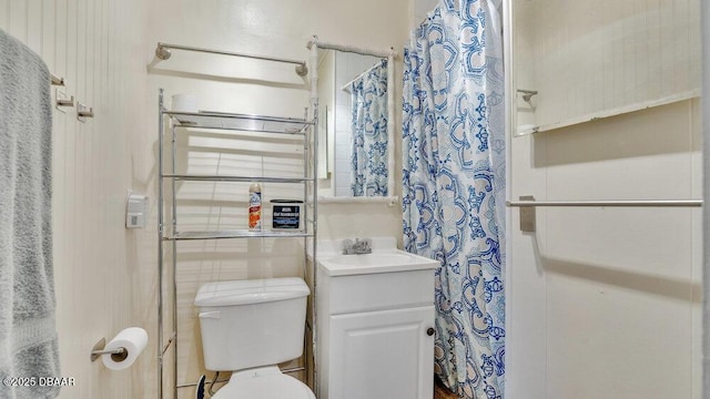 bathroom featuring vanity, curtained shower, and toilet