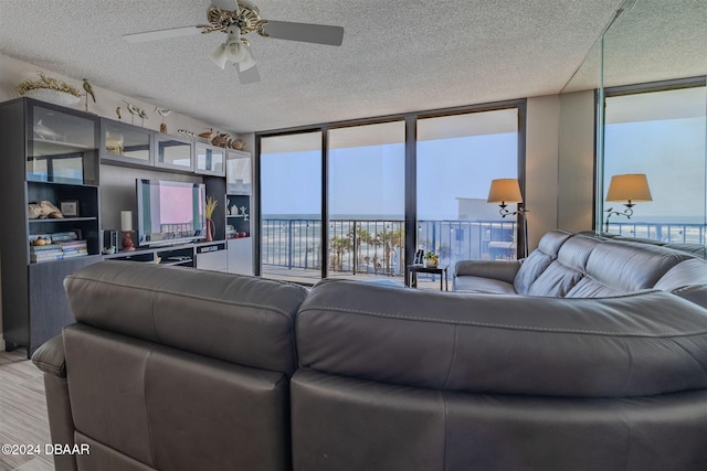 living room with floor to ceiling windows, a textured ceiling, and hardwood / wood-style flooring