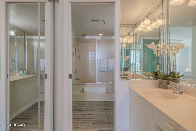 bathroom featuring vanity and combined bath / shower with glass door