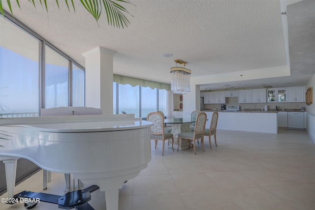 dining space featuring a chandelier, a textured ceiling, and light tile patterned flooring