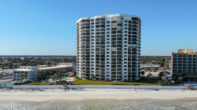 view of property featuring a view of the beach and a water view