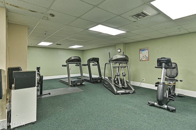 gym with a paneled ceiling