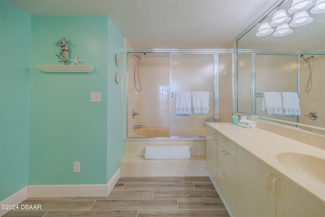 bathroom with bath / shower combo with glass door and vanity