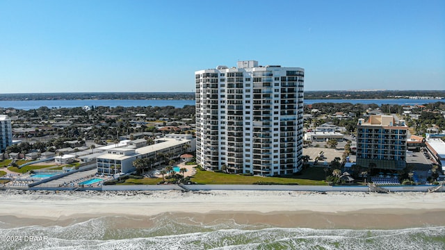 birds eye view of property featuring a water view and a beach view