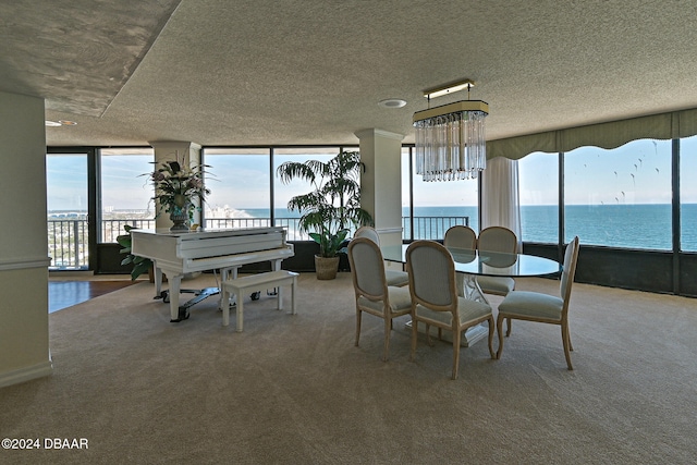 dining space with carpet, expansive windows, and a water view