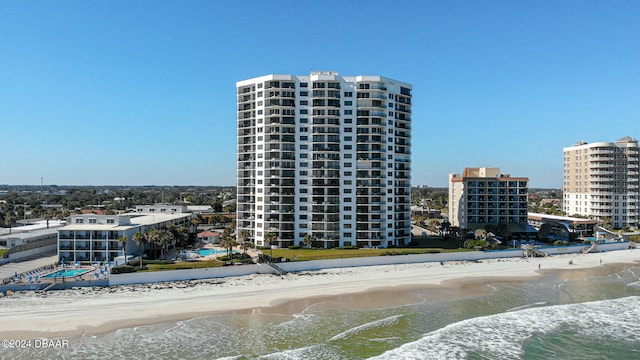 view of property with a view of the beach and a water view