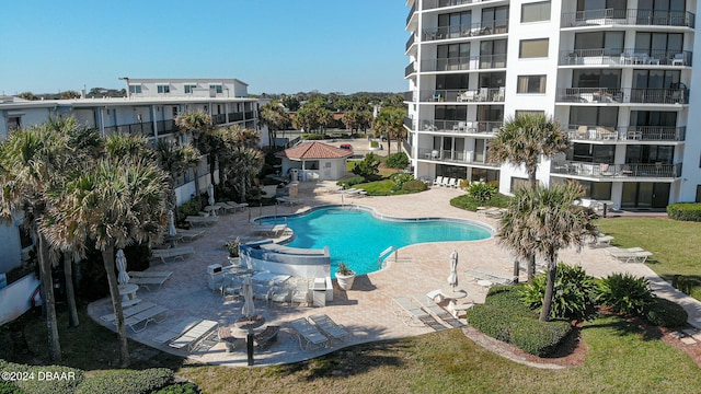 view of swimming pool with a lawn and a patio area