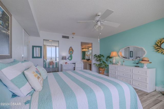 bedroom with ceiling fan, a textured ceiling, and light hardwood / wood-style flooring